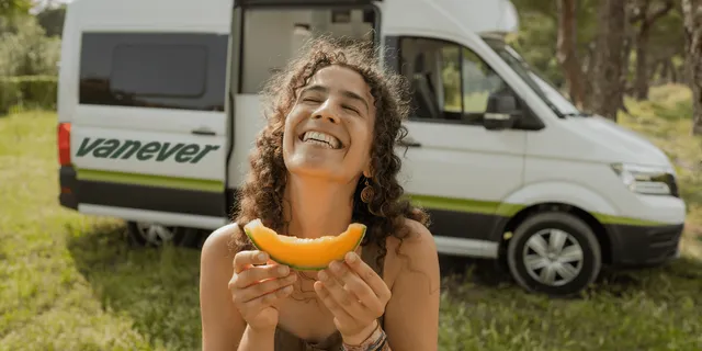 Women laughing in front of VW Grand California Campervan