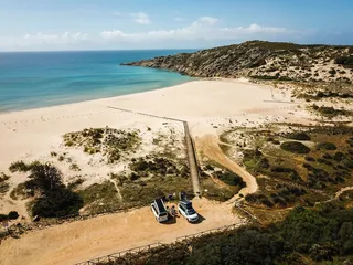The sea, beach and two bird-eye campers.